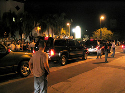 Black SUVs transport candidates to, from events